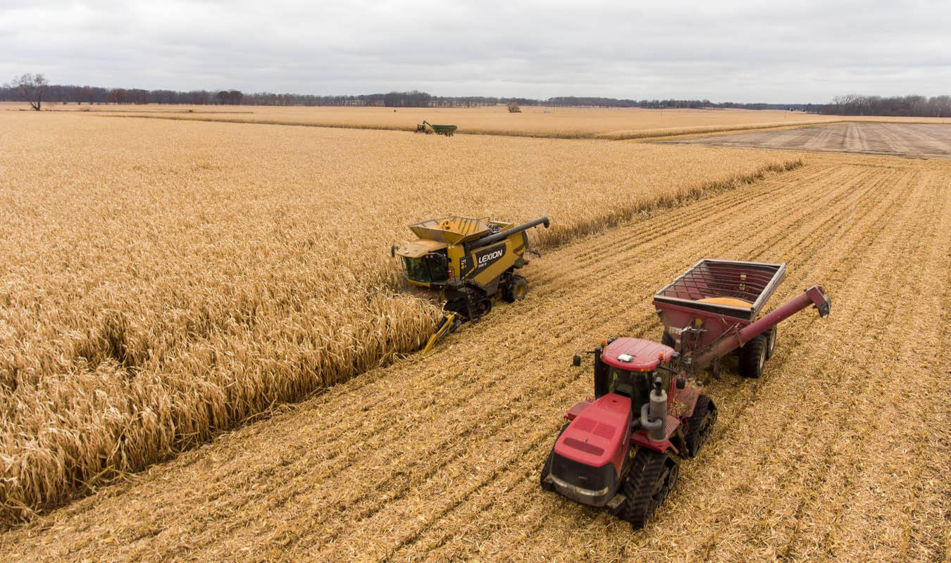 tractor and header in grain field