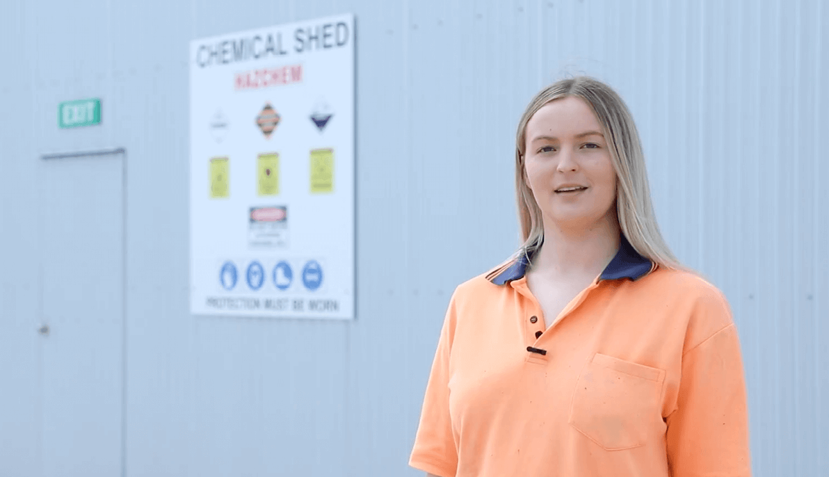 Person standing in front of chemical shed