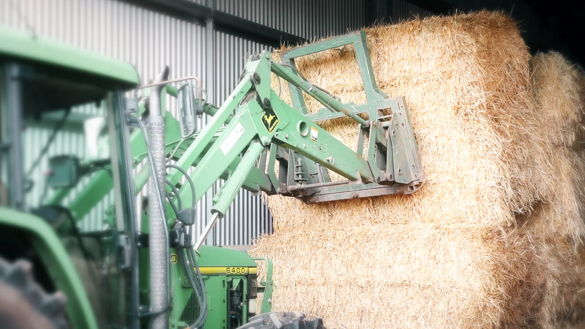 Telehandler stacking hay bales