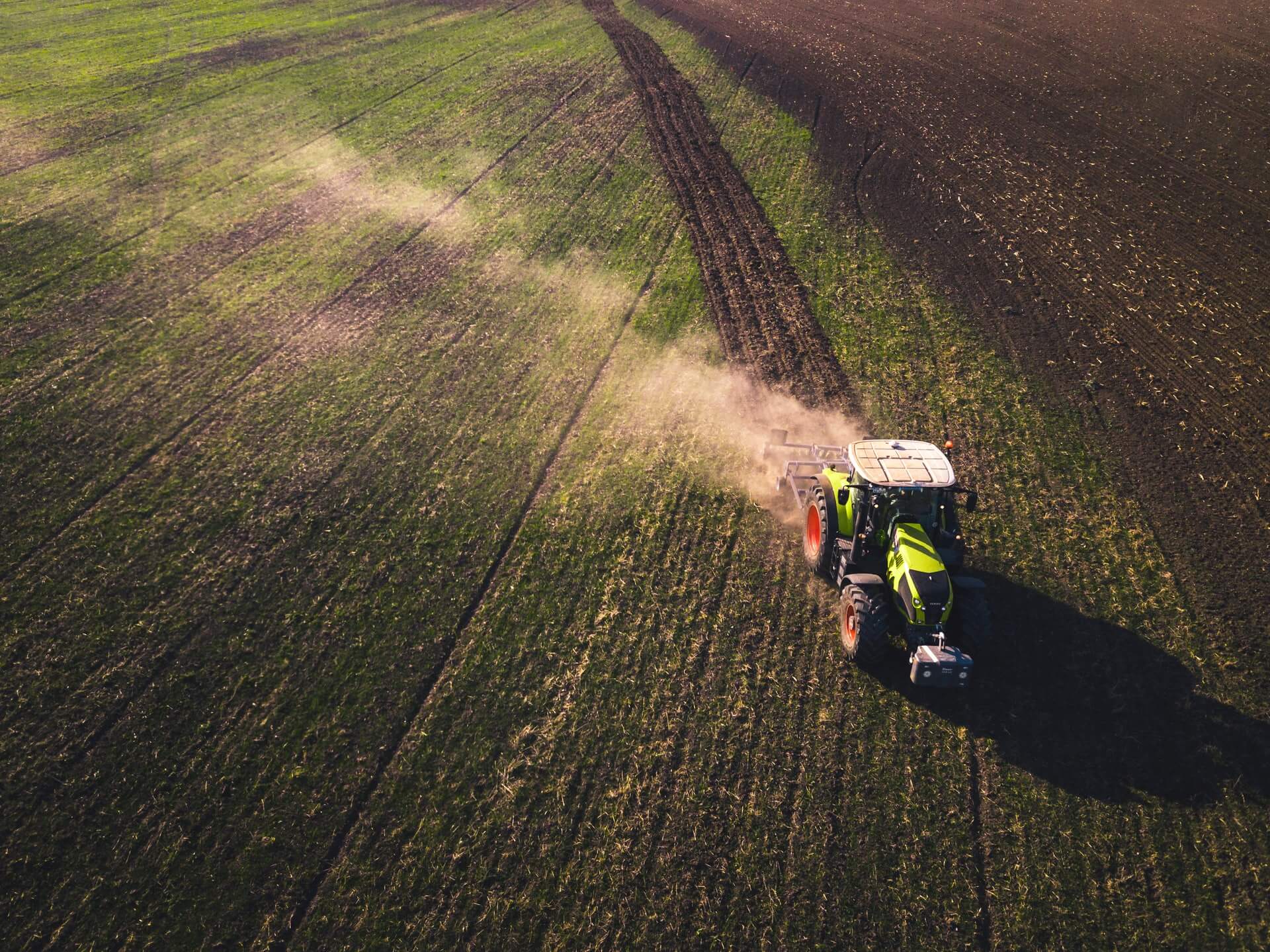 Farm Tractor driving in field