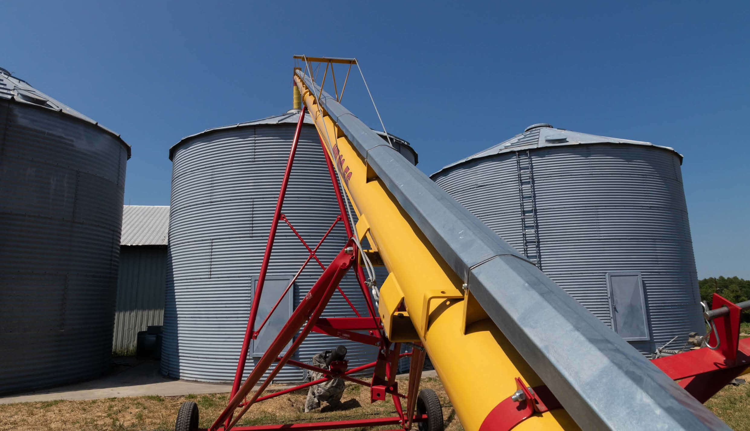 Grain auger and farm silos